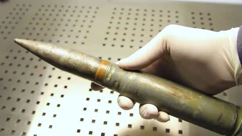 Hands in rubber gloves holding a projectile close-up Stock Footage 222189503