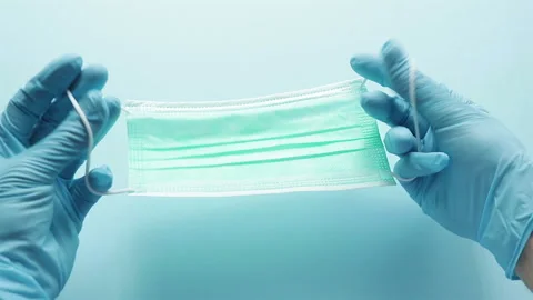 Hands in rubber gloves put on protective mask first person view coronavirus t Stock Footage 126698157