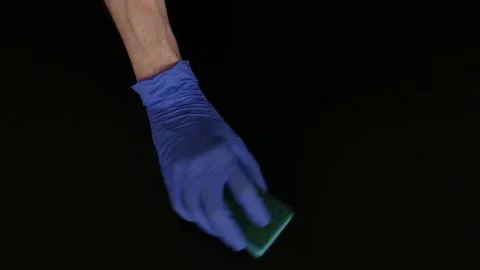 Hands in rubber gloves rub the dirt with a sponge. Cleaning. Top view Stock Footage 105959980
