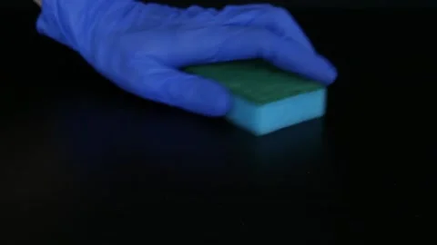 Hands in rubber gloves rub the dirt with a sponge. Cleaning Stock Footage 105959992