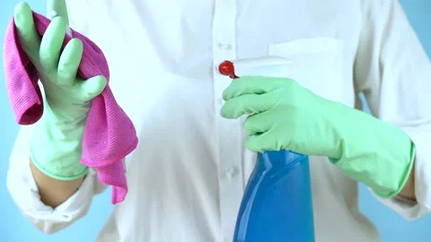 Hands in rubber protective gloves hold a white spray bottle and a wet rag. Stock Footage 149487935