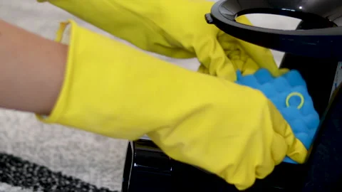 Hands in rubber yellow gloves vacuum cleaner kit sponge dust container Video stock 221772249