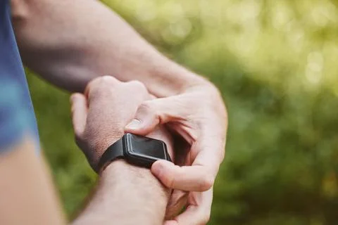 Hands, runner and check smart watch in park for steps, data or time app with Stock Photos