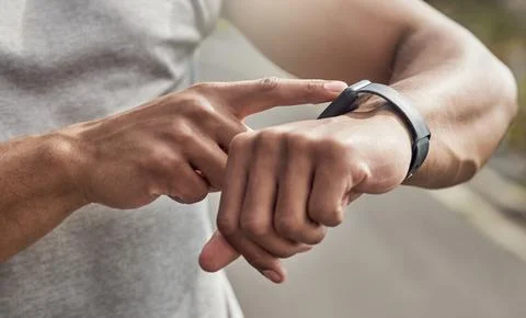Hands, runner and check with smart watch in street for stats, heart rate an.. Stock Photos