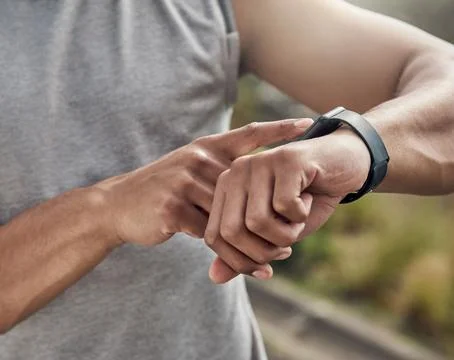 Hands, runner and click with smart watch in street for stats, heart rate an.. Stock Photos