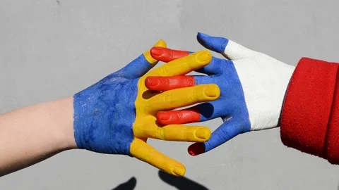 Hands of russian and ukrainian flags colors, symbol of truce and consent between Stock Footage 172313619