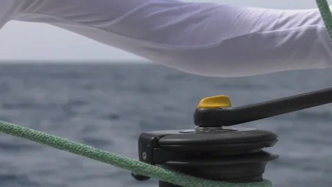 Hands of a sailor pulling rope around a winch . Stock Footage 121248862