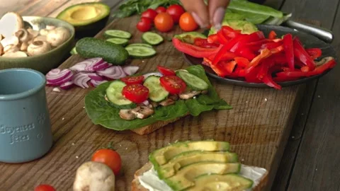 Hands salted full grain bread with avocado for vegan breakfast Stock Footage 160850563