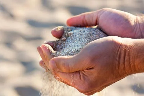 Hands with sand Stock Photos