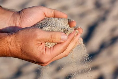 Hands with sand Stock Photos