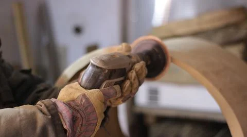 Hands with a sander work with wood material Stock Photos