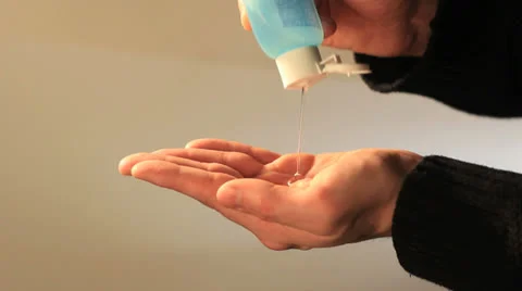 Hands sanitizing close up studio Stockbeeldmateriaal 24786312