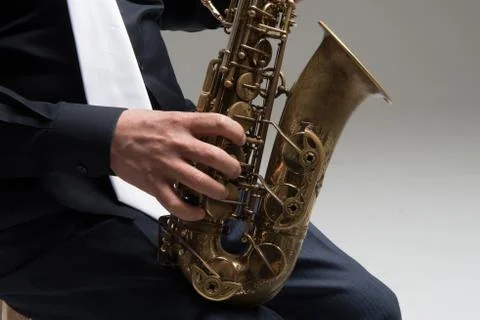 Hands of saxophone player Stock Photos