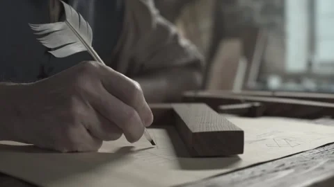 Hands of a scholar marking precise intervals on a straight line with a quill pen Stock Footage 340079600