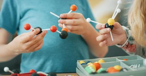 Hands, science and children with atom model for project, discovery or assig.. Stock Photos