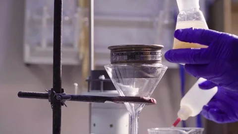 The hands of the scientist filter the sample Stock-Footage 87951781