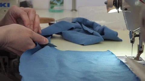 Hands with scissors cut fabric close-up Video stock 130829865