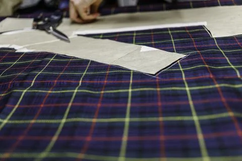 Hands with scissors on the fabric Stock Photos