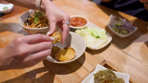 Hands Scooping Grilled Crab Paste from Shell at Thai Restaurant Video stock 335612428