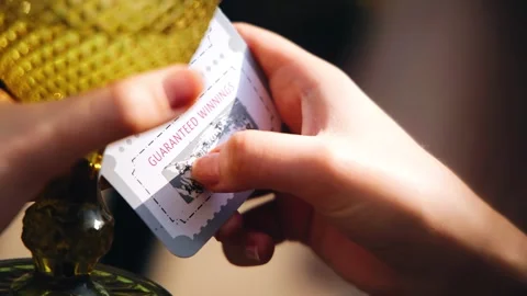 Hands scrape the protective coating off the lottery ticket Stock Footage 328514176