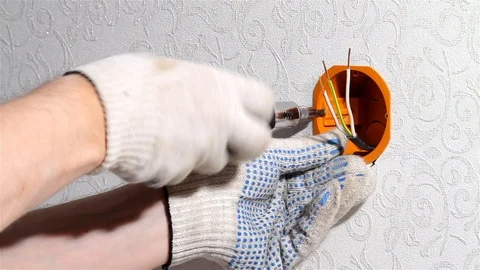 Hands with a screwdriver tighten the screw Stock Footage 126747549