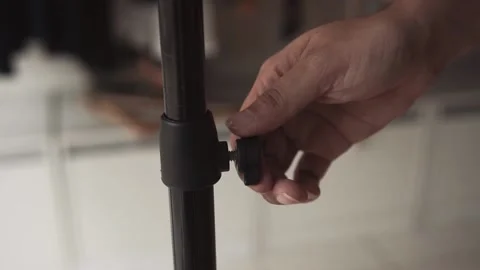 Hands screwing a bolt into the pole. Stock Footage 136277267