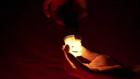 Hands Screwing Energy Saving Light Bulb Into Socket Under Dark Red Lighting Stock Footage 333828332