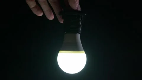 Hands Screwing Flickering Led Light Bulb Into Socket in Darkness Stock Footage 334134477