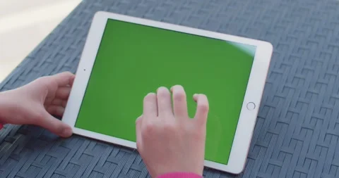Hands scrolling and selecting content on tablet with green screen mockup display Stock Footage 345448469
