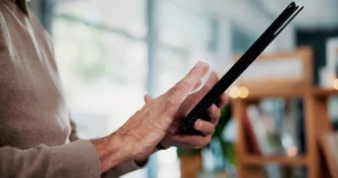 Hands, scrolling and tablet with old person in home living room for connectivity Stock Footage 336302227
