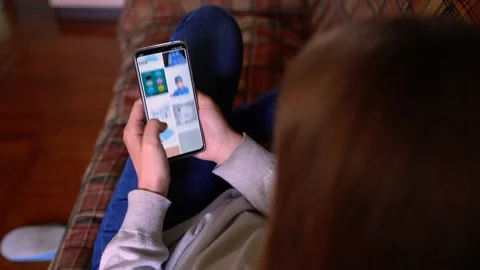 Hands scrolling the mobile phone Stock Footage 130597342