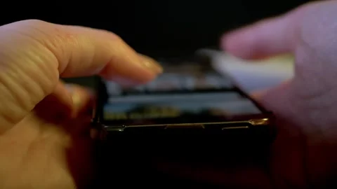 Hands Scrolling Smartphone Screen In Dark With Flashing Colorful Neon Lights 库存影片 330110187