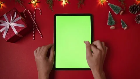 Hands scrolling, tapping, zooming pages on tablet with green screen. Chroma k Stock Footage 220788135