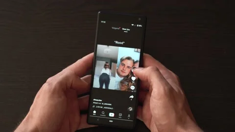 Hands scrolling through TikTok feed after ban on the app, doing swiping, Stock Footage 139604910