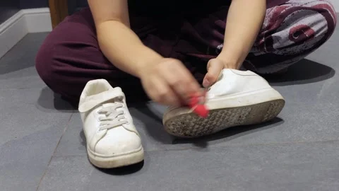 Hands scrub dirty sneaker on gray tile 스톡 동영상 337955420