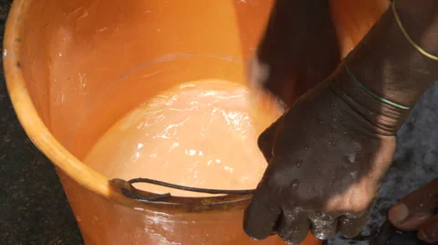 Hands scrubbing orange bucket Stock Footage 38538202