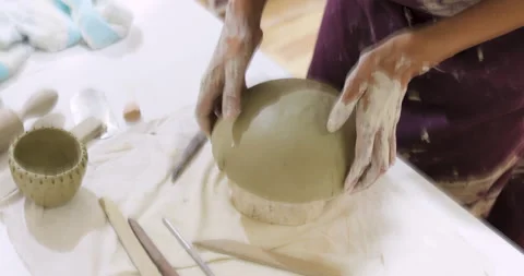 Hands Sculpting Clay Over Rounded Mold in Artisan Workshop Stock Footage 304412558