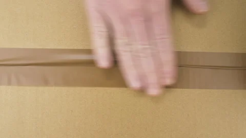 Hands sealing cardboard box Stock Footage 247781774
