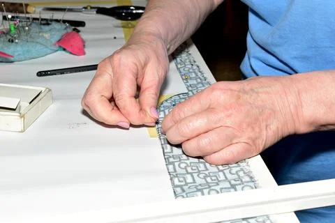 Hands of a seamstress cutter at work. Stock Photos