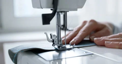 Hands of a seamstress working on a sewing machine. Stock Footage 151787131
