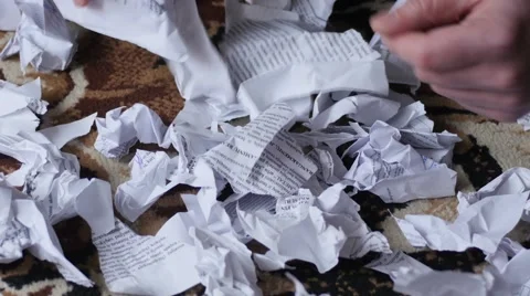 Hands searching among torn and crushed documents on the floor Stock Footage 48650488