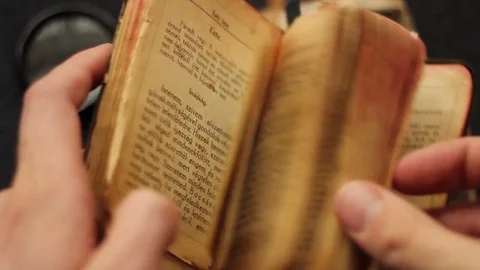 Hands searching in a religious book Video stock 73830182
