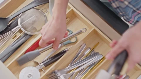 Hands searching for scissors inside kitchen drawer with mixed utensils Stock Footage 328197707