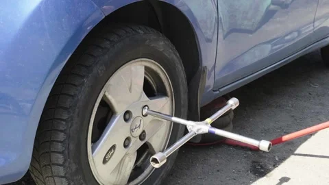 Hands of a senior auto mechanic changing tires Stock Footage 273448185