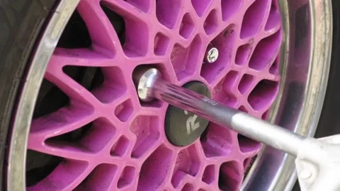 Hands of a senior auto mechanic changing tires Stock Footage 273450246