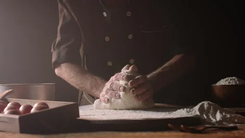 Hands of senior experienced chef kneading floured dough at bakery, old man Stock Footage 138642682