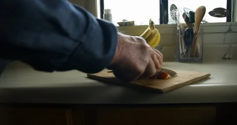 Hands of senior man cutting fruit. Stock Footage 88374437