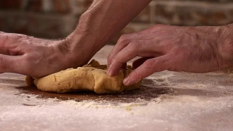 Hands of senior professional chef kneading floured dough for pasta. Retiree Stock Footage 148640050