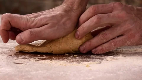 Hands of senior professional chef kneading floured dough for pasta. Retiree Stock Footage 148677582
