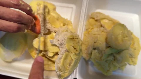 Hands Separating Durian Flesh From Seed Stock Footage 336708902